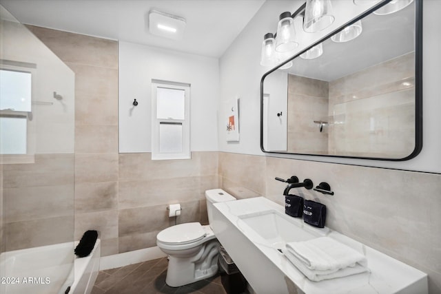 bathroom with toilet and tile walls