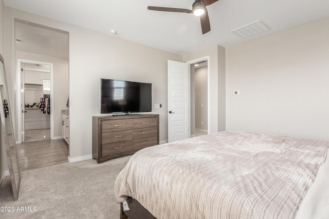 bedroom featuring ceiling fan and light carpet