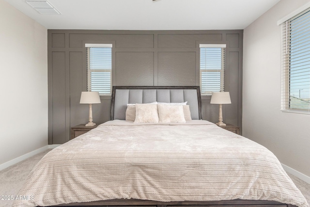 carpeted bedroom featuring multiple windows