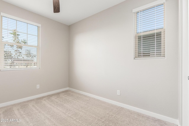 unfurnished room with ceiling fan and light colored carpet