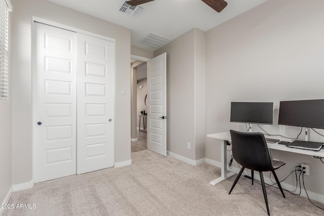 home office featuring light carpet and ceiling fan