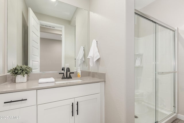 bathroom with an enclosed shower and vanity