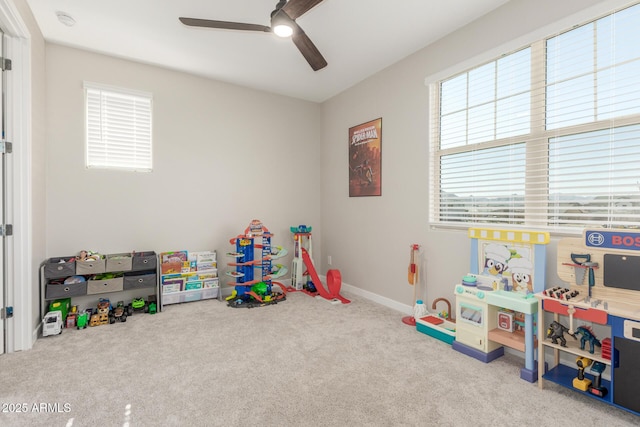 playroom with ceiling fan and light carpet