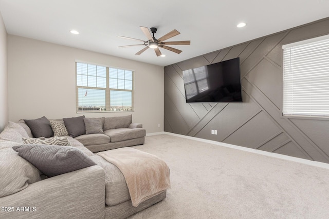 carpeted living room with ceiling fan