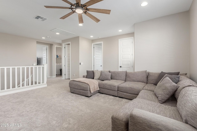 living room featuring ceiling fan and light colored carpet