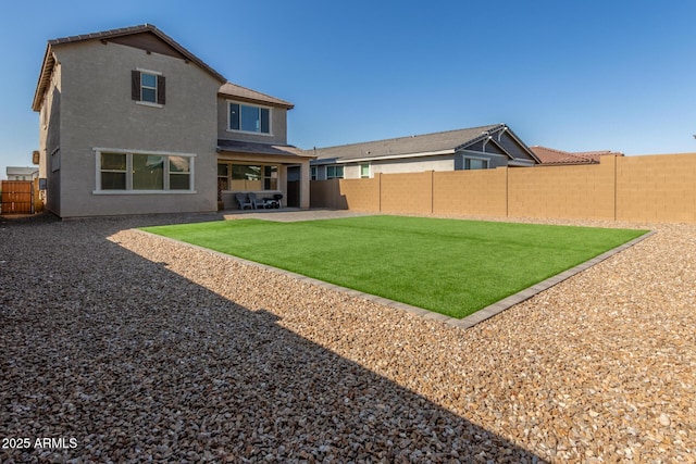 rear view of property featuring a patio