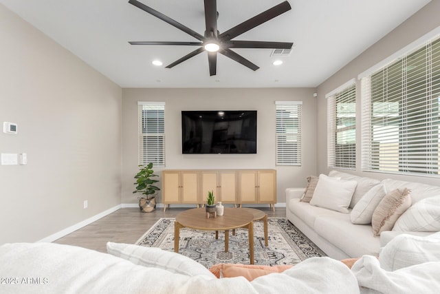 living room with ceiling fan and light wood-type flooring