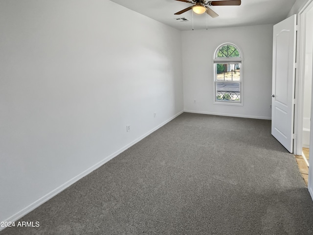 unfurnished bedroom featuring carpet, visible vents, baseboards, and a ceiling fan