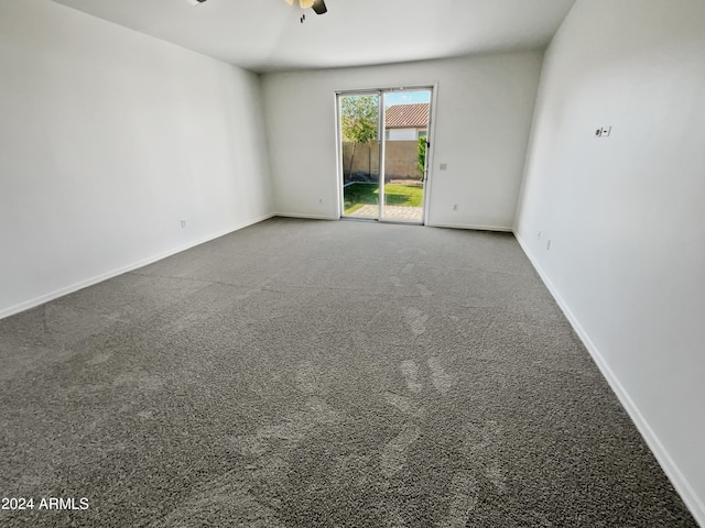 empty room featuring carpet flooring, ceiling fan, and baseboards