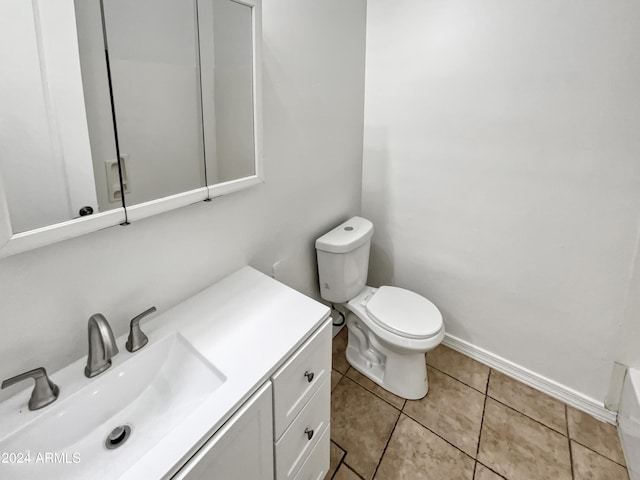 bathroom with baseboards, vanity, toilet, and tile patterned floors