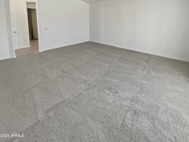 empty room with carpet floors and baseboards