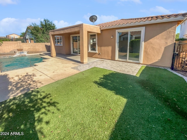 rear view of house featuring a fenced backyard, a fenced in pool, a patio, and stucco siding