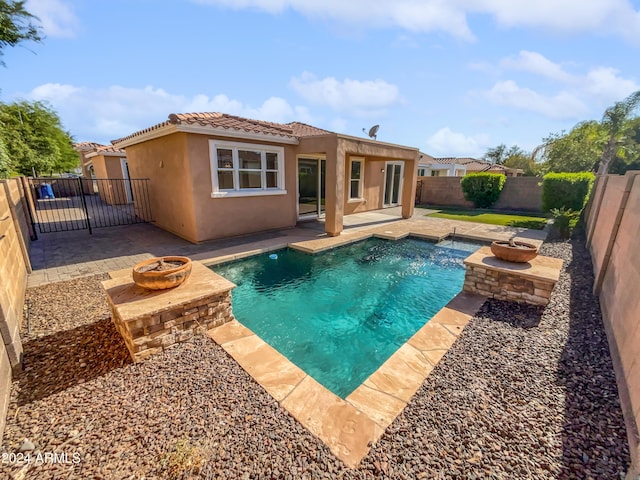 view of pool featuring a fenced backyard, a patio, and a fire pit