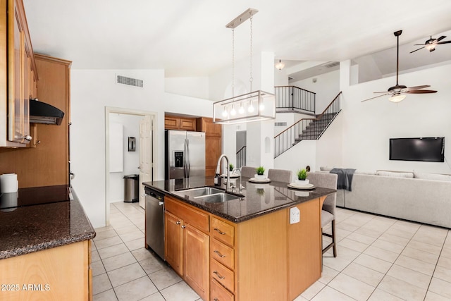 kitchen with visible vents, light tile patterned flooring, a sink, stainless steel appliances, and open floor plan