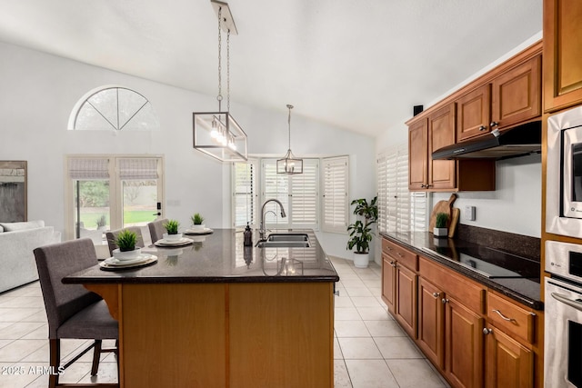 kitchen featuring oven, under cabinet range hood, light tile patterned floors, black electric cooktop, and a sink