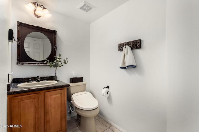 half bathroom featuring visible vents, toilet, vanity, and tile patterned flooring