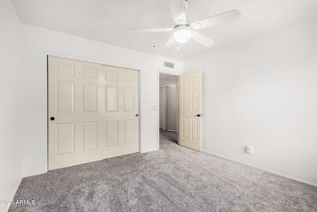 unfurnished bedroom with visible vents, carpet floors, a closet, and ceiling fan