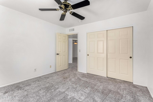 unfurnished bedroom with visible vents, baseboards, a closet, and carpet flooring