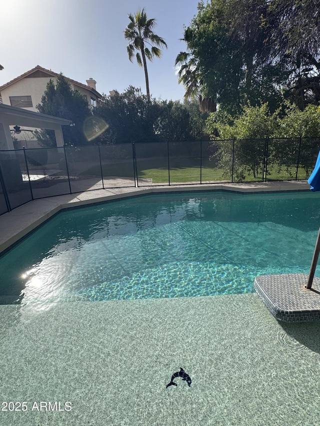 view of swimming pool with a fenced in pool, a water slide, and fence