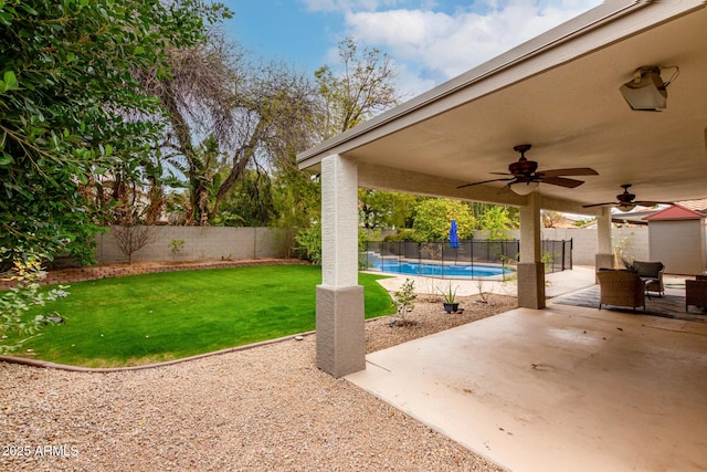 view of patio featuring a fenced backyard, a fenced in pool, and ceiling fan