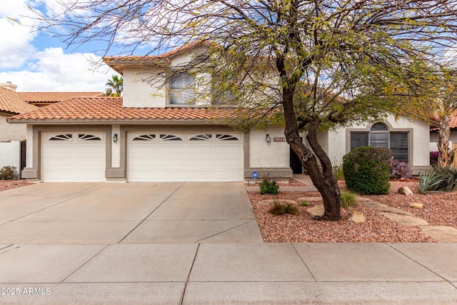 view of front of property with a chimney, a tile roof, stucco siding, and concrete driveway