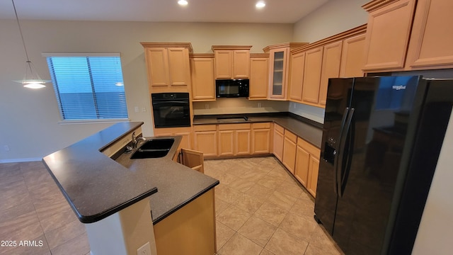 kitchen with dark countertops, recessed lighting, glass insert cabinets, a sink, and black appliances