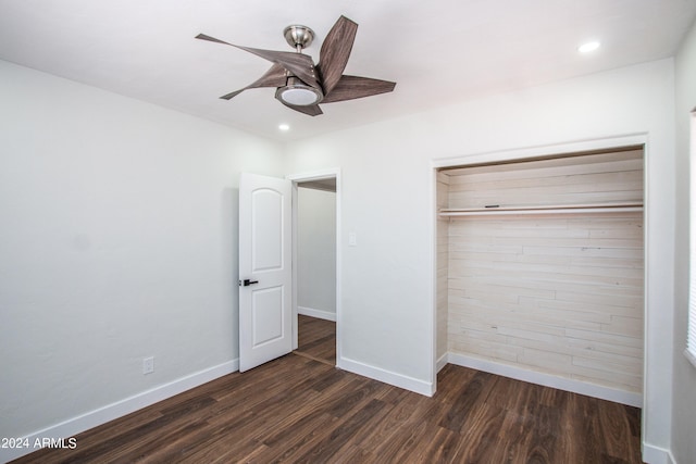 unfurnished bedroom featuring dark wood-type flooring, a closet, and ceiling fan