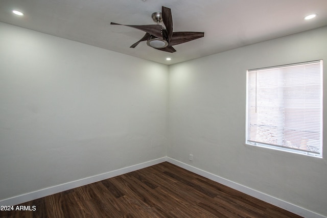 empty room with dark hardwood / wood-style floors and ceiling fan