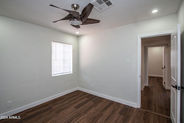 spare room with ceiling fan and dark wood-type flooring