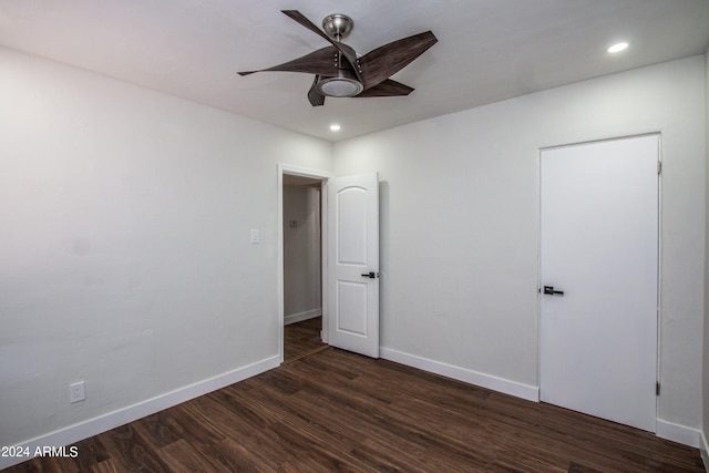 unfurnished room with ceiling fan and dark hardwood / wood-style flooring