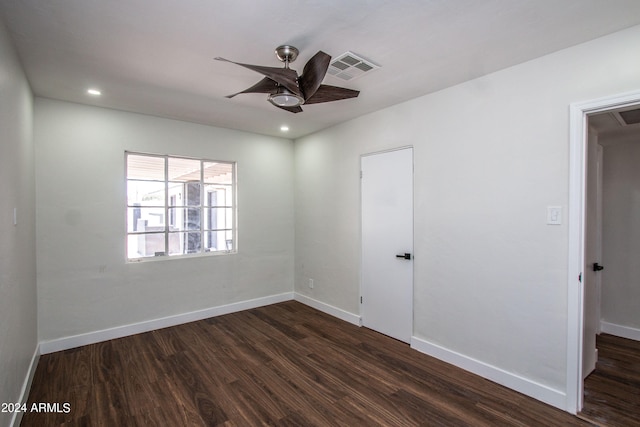 empty room featuring ceiling fan and dark hardwood / wood-style flooring