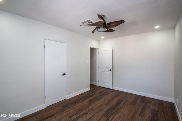 unfurnished room with ceiling fan and dark hardwood / wood-style flooring