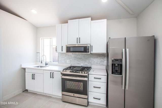 kitchen featuring white cabinets, appliances with stainless steel finishes, tasteful backsplash, and sink