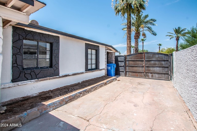 view of side of home featuring a patio area