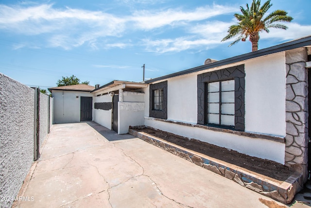 view of side of property with a patio