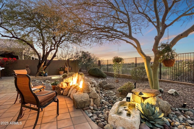 patio terrace at dusk with a fire pit