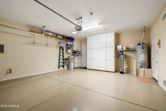 garage with water heater and a garage door opener