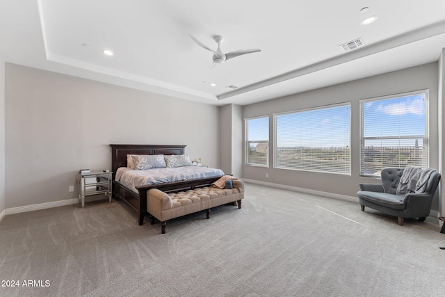 bedroom with multiple windows, light colored carpet, and ceiling fan