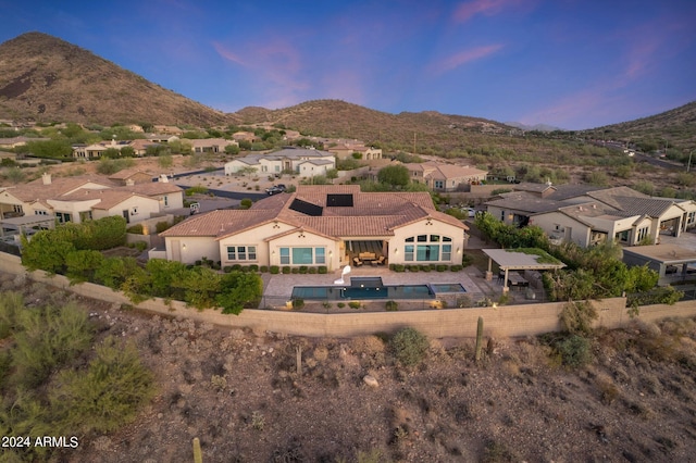 exterior space featuring a mountain view and a patio area