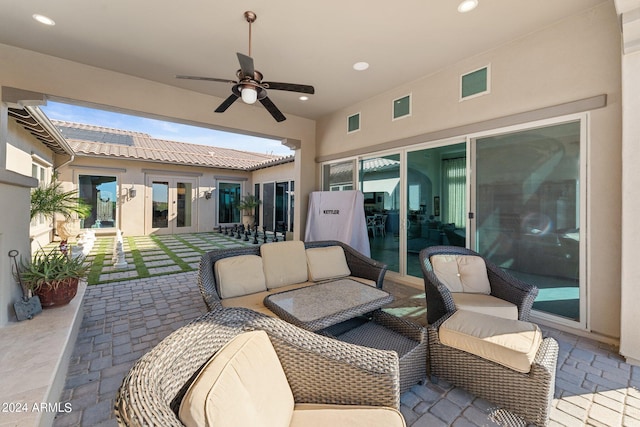 view of patio / terrace featuring french doors, ceiling fan, and an outdoor living space