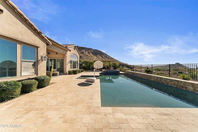 view of swimming pool featuring a mountain view and a patio area