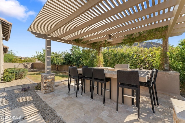 view of patio featuring a bar and a pergola