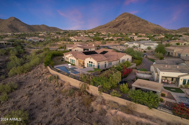 aerial view at dusk featuring a mountain view