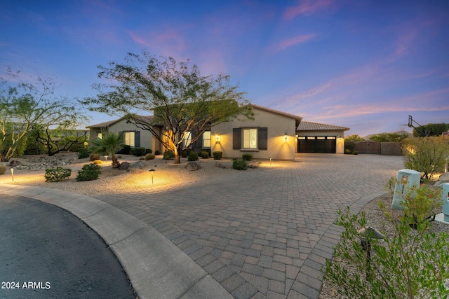 view of front of house featuring a garage and a carport