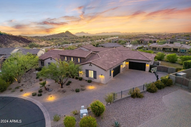 aerial view at dusk featuring a mountain view