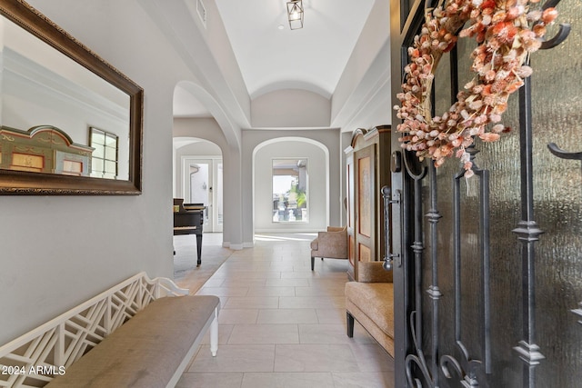 tiled entrance foyer featuring lofted ceiling