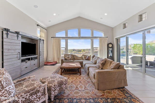 tiled living room featuring a healthy amount of sunlight and high vaulted ceiling