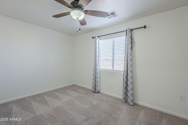 spare room with ceiling fan and light carpet