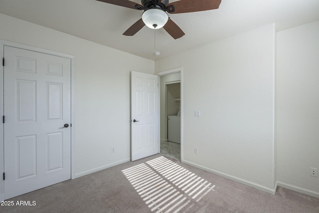 unfurnished bedroom with light colored carpet, ceiling fan, and washer / dryer