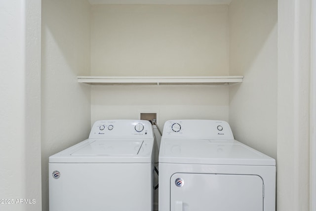 clothes washing area with separate washer and dryer